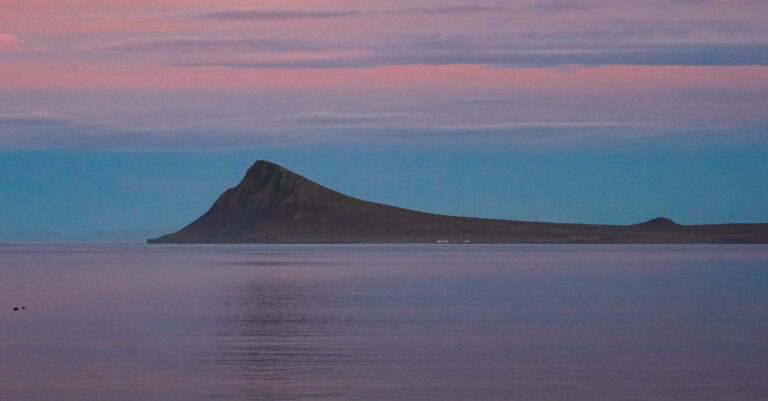 Serene sea, sunset and mountain